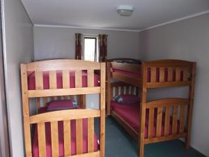 
two bunk beds in a small room at Arrowtown Holiday Park in Arrowtown
