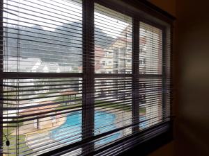 a window with a view of a building at Jeffrey Homestay B @ Lost World of Tambun in Ipoh