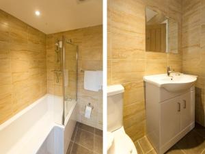 a bathroom with a sink and a shower and a toilet at 1 Suffolk Cottage in Aldeburgh