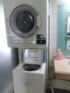 a washing machine sitting on top of a dryer at Prince Hotel Shimonoseki in Shimonoseki