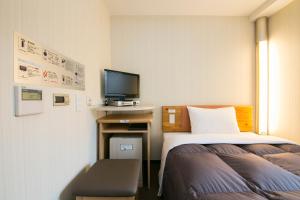 Säng eller sängar i ett rum på R&B Hotel Umeda East