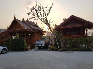 a house with a truck parked in front of it at Good Home@Udon Thani Resort in Ban Nong Khun