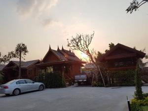 a white car parked in front of a house at Good Home@Udon Thani Resort in Ban Nong Khun
