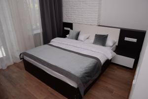 a bedroom with a large bed with pillows at Guest House Gantiadi in Batumi