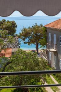 a view of the ocean from a balcony at Apartments Ivandić in Tučepi