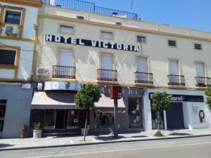a building on the corner of a street at Hotel Victoria in Zafra