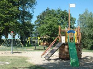 a playground with a slide and a swing at Jadgschloss zu Hohen Niendorf in Hohen Niendorf +7 photos