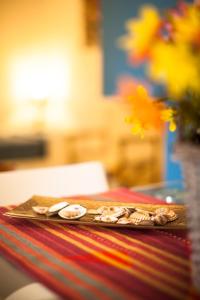 a cutting board with food on top of a table at Grace's Place in Scopello