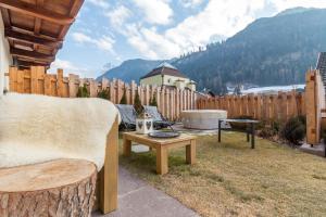 a backyard with a chair and a table and a fence at Chalet O New! in Ortisei