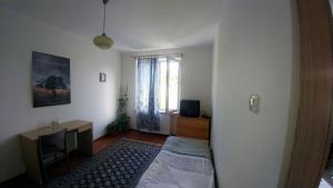 グダニスクにあるCiche miejsceのベッド、デスク、窓が備わる客室です。