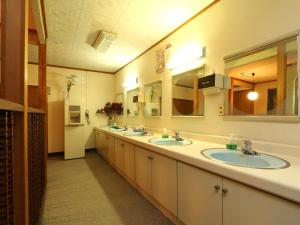 ein Badezimmer mit zwei Waschbecken und zwei Spiegeln in der Unterkunft Lodge Tsubaki in Otari