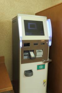 an atm machine with a phone on top of it at R&B Hotel Sapporo Kita 3 Nishi 2 in Sapporo