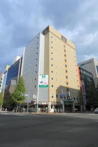a large building on the side of a street at R&B Hotel Sapporo Kita 3 Nishi 2 in Sapporo