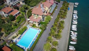 an aerial view of a house with a pool and boats at Hotel Della Baia in Portovenere