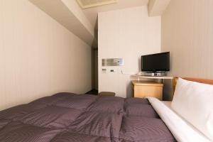 Postel nebo postele na pokoji v ubytování R&B Hotel Nagoya Sakae Higashi