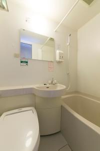 a bathroom with a toilet and a sink and a tub at R&B Hotel Nagoya Sakae Higashi in Nagoya