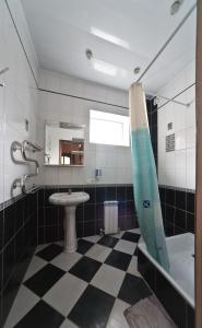 a bathroom with a shower, sink, and toilet at HZ Hostel in Krasnodar