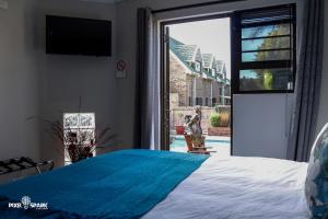 a bedroom with a bed and a large window at Tyday Accommodation in Port Elizabeth