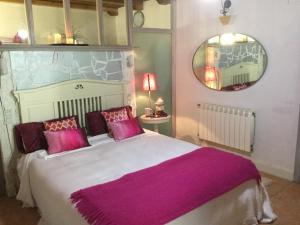 Bisalde في باكيو: غرفة نوم مع سرير كبير مع وسائد أرجوانية ومرآة