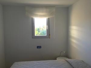 a bedroom with a bed and a window at Oliva Nova Casas del Mar in Oliva +59 photos