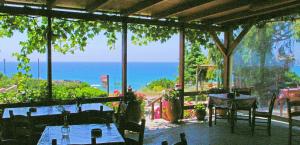 a restaurant with a view of the ocean at Zorbas Rooms in Frangokastello