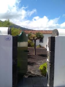 a gate to a yard with a house at Casa Comprida in Santo Amaro