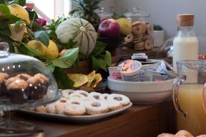 a table with plates of donuts and milk on it at Hotel Soleluna in Piano di Sorrento