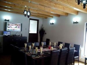 a dining room with a long table and chairs at Cabana Alexandra in Moisei