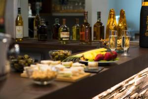 a bar with food and bottles of wine and glasses at Hotel Soleluna in Piano di Sorrento