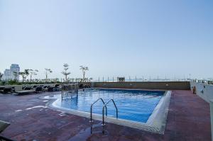 a large swimming pool on top of a building at Icon Casa Living - Classy High Floor - Elite Residence in Dubai
