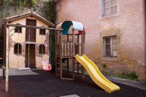 a playground with a slide in front of a building at La Casona de Molleda in Unquera