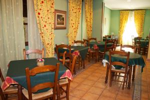 a dining room with green tables and chairs at La Casona de Molleda in Unquera