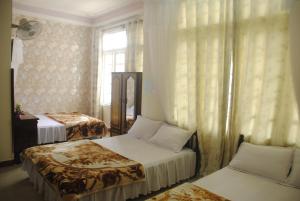 מיטה או מיטות בחדר ב-Hoang Trang Hotel
