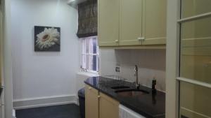 a kitchen with a sink and a flower on the wall at Parliament Square - Royal Mile in Edinburgh