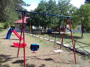 a group of swings in a park at Amarantos in Loutra Amarantou