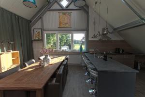 a kitchen with a long wooden table and chairs at Holiday Home Odoorn in Odoorn