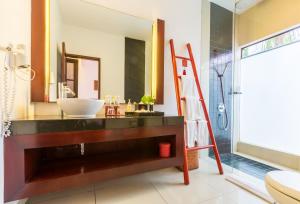 a bathroom with a sink and a mirror at Kamar Kamar Boutique Hotel in Seminyak