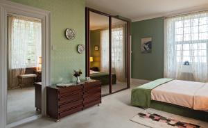 a bedroom with a bed and a large mirror at Glanleam House in Valentia Island