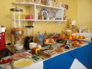 a table with many plates of food on it at Hotel Scilla in Scilla