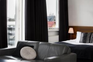 a living room with a couch and a bed and a window at Room With a View Apartments in Reykjavík
