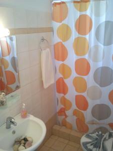 a bathroom with a shower curtain and a sink at Vigles in Adamantas