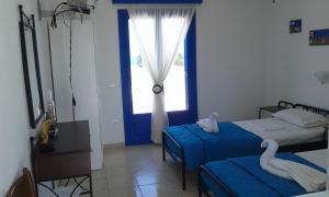 a bedroom with two beds and a window at Vigles in Adamantas