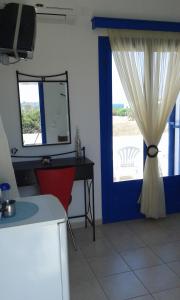 a room with a door with a mirror and a desk at Vigles in Adamantas