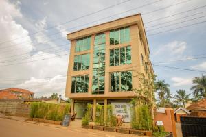 a tall building with glass windows at Eight Winx Hotel in Kampala