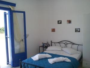 a bedroom with a bed with two pillows on it at Vigles in Adamantas
