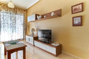 a living room with a flat screen tv on a wall at Espanhouse La Zenia 109 in Orihuela Costa