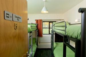 a room with two bunk beds and a window at YHA Dartmoor in Postbridge