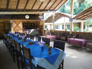 a group of tables with blue table cloths and chairs at Racy Shade Resort Pvt.Ltd. in Bardiyā