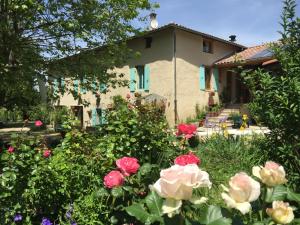 a house with a garden of flowers in front of it at La Source, Vegetarian Guest House in Chabeuil