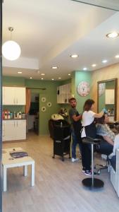 a group of people standing in a hair salon at Camlikosk Apart Hotel in Bodrum City